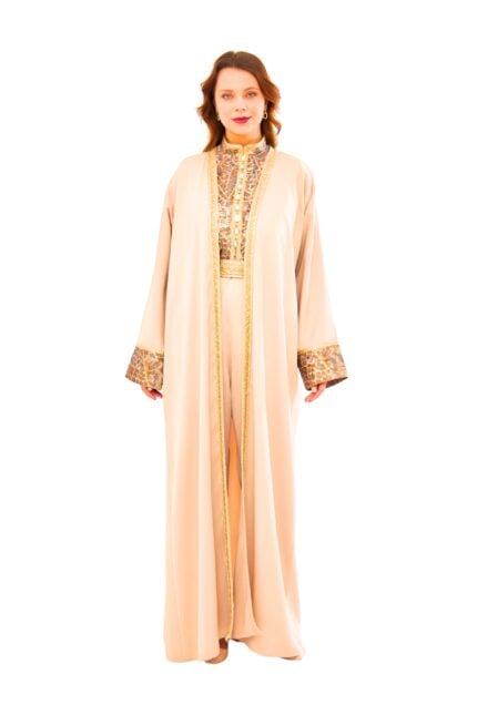 Model wearing the Desert Mirage Embellished Set: a flowing cream-beige outer robe paired with a matching wide-leg jumpsuit featuring an intricately embellished gold mosaic bodice panel, metallic textured cuffs, and a coordinating belt.