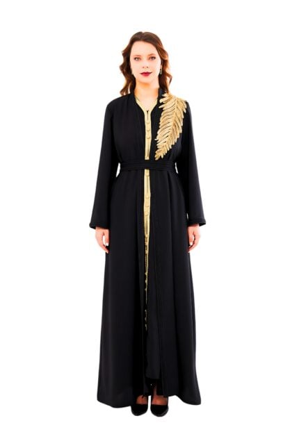 Model showcasing the Golden Palm Noir Abaya: a sleek black overgarment with metallic gold palm leaf embroidery along the sleeves and hem, featuring a relaxed fit and concealed snap closures.
