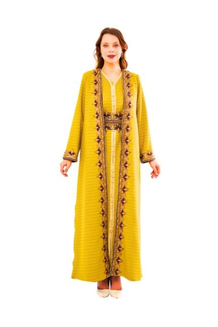 Model wearing the Saffron Majesty Kaftan: a saffron-hued textured kaftan with intricate maroon and gold floral embroidery along the front opening, cuffs, and matching waist belt.
